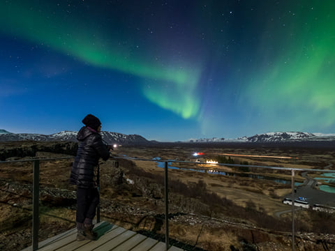 A traveller watching the Northern Lights
