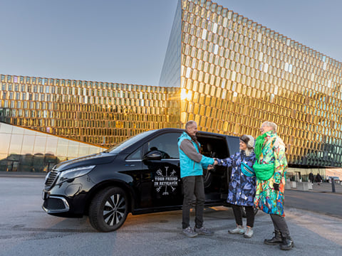 Travellers meeting a Guide from Your Friend in Reykjavik in front of the Harpa Concert Hall