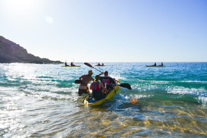 kayak Los Cabos launching from beach ocean start two bays adventure Baja.