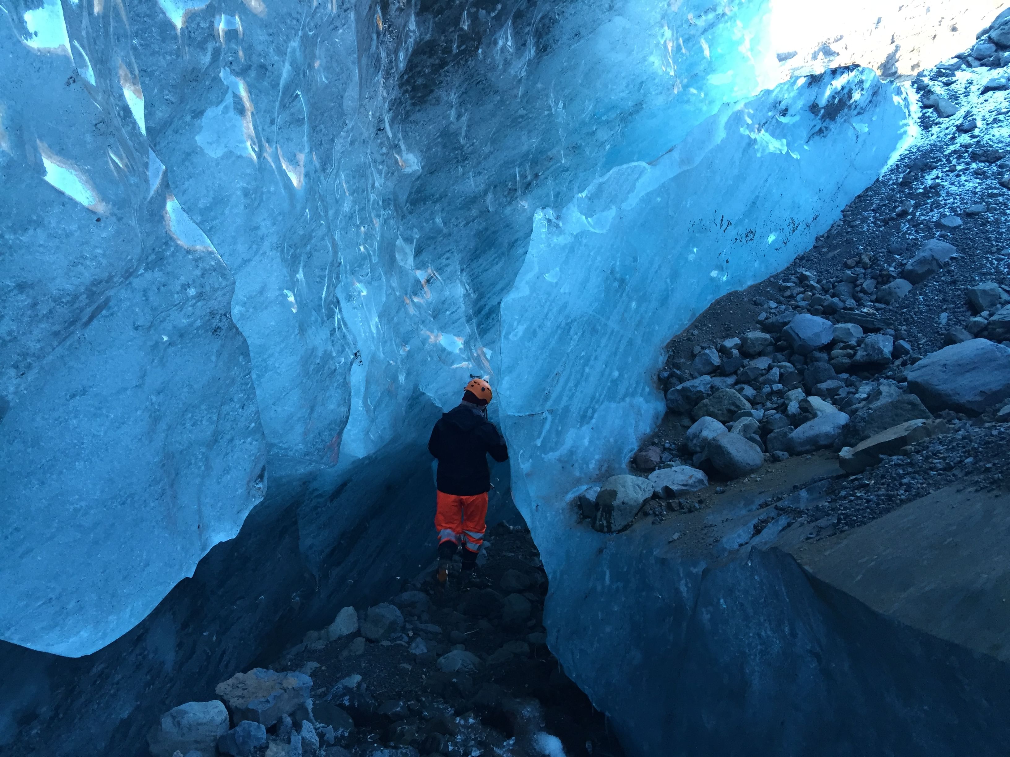 Hiker exploring Skaftafell ice cave during 3 day south coast iceland tour