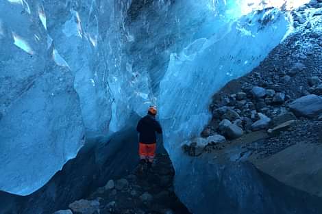 Hiker exploring Skaftafell ice cave during 3 day south coast iceland tour