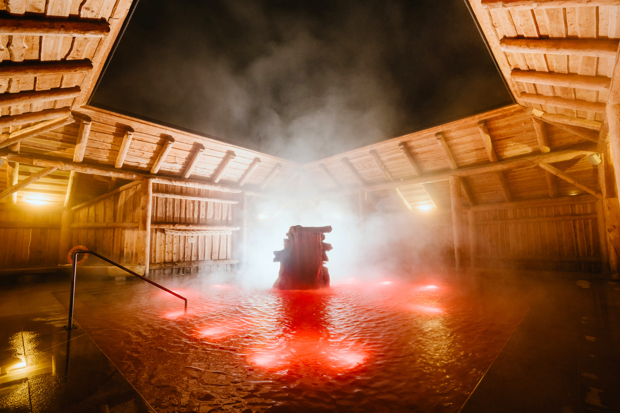 Gorący Potok thermal pool night red light steam — unique sulphur baths Szaflary winter atmosphere
