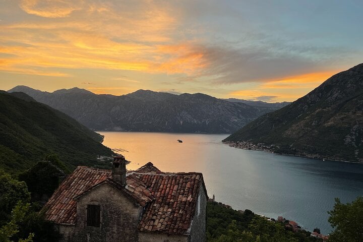 Stone house with sunset views over Perast and the iconic islands of Our Lady of the Rocks and St. George in the Bay of Kotor.