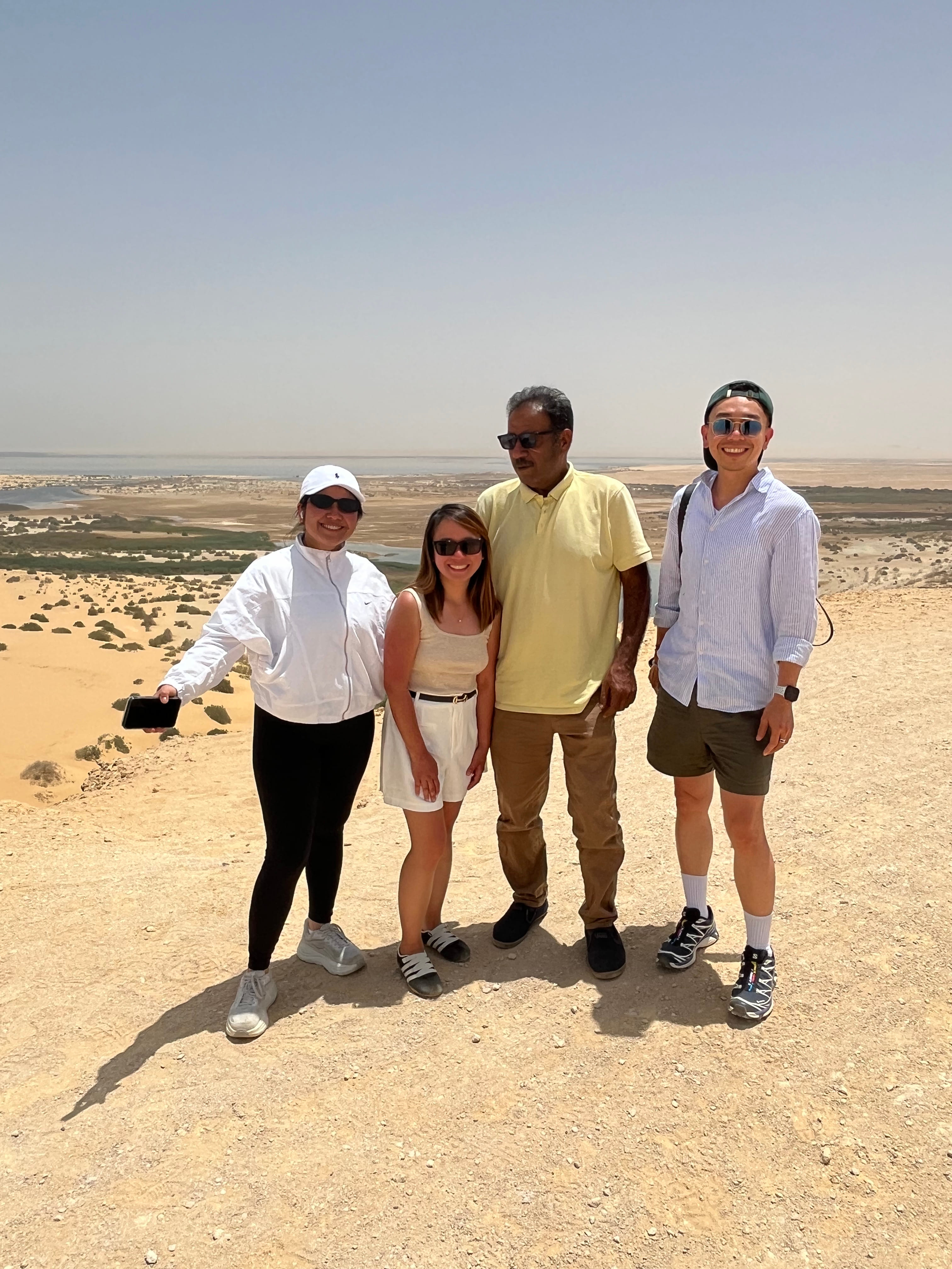 Traveler sandboarding on desert dunes in Fayoum Egypt