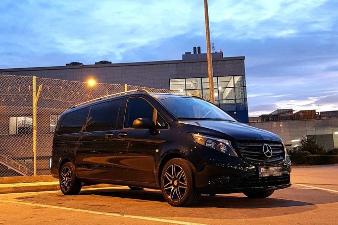 Interior of a modern air-conditioned minivan used for private transfers from Santorini Airport to Oia.