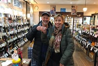 Trying sake in a liquor store on Jujo's famous shopping street.