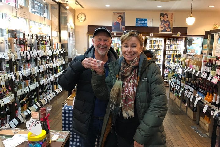 Trying sake in a liquor store on Jujo's famous shopping street.