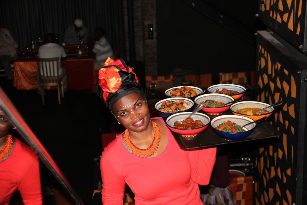 Selection of sharing dishes (curry, salad, skewers, soup) in the 14-dish tasting menu at Gold Restaurant, Cape Town.