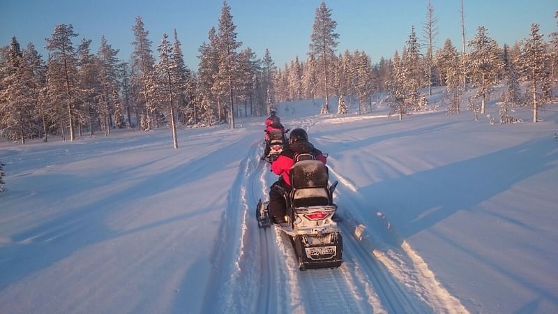 Snowmobile tour group in snow surroundings