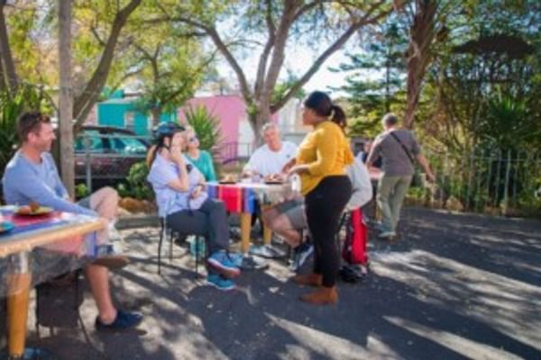 Cycle group stopping at an outdoor café in historic Bo-Kaap.