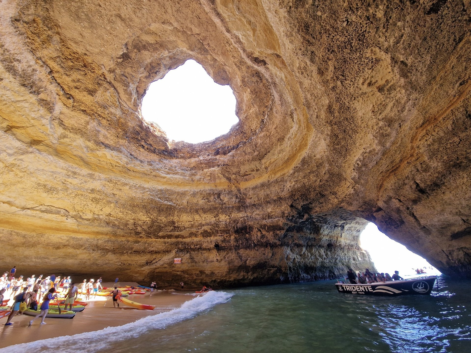The Benagil sea cave with its round opening and the beach below