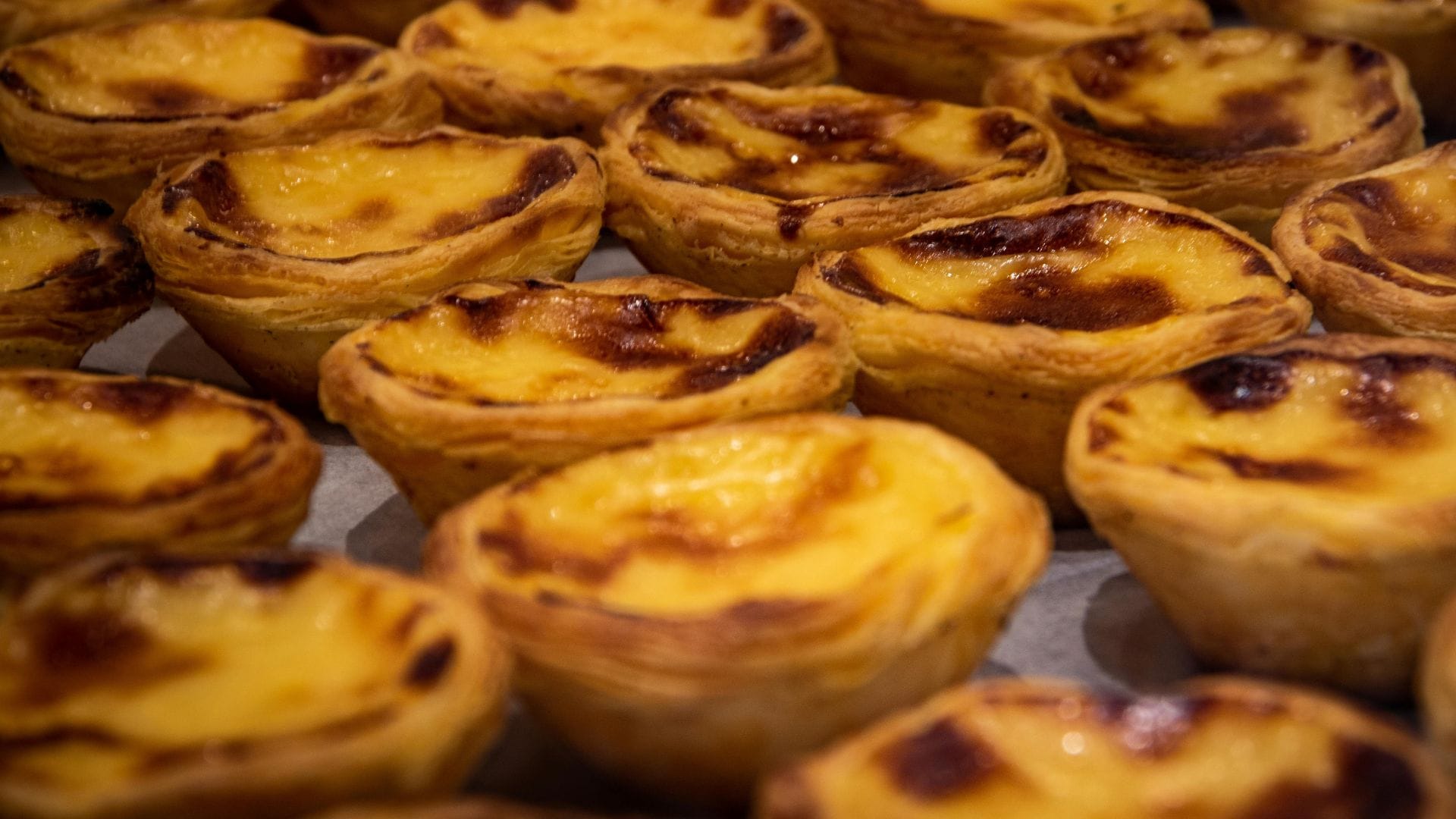 Freshly baked Portuguese custard tarts (pastéis de nata) with golden, caramelized tops