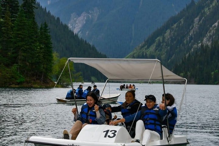 Forest lake in the Tian Shan mountains with calm water and mountain scenery.