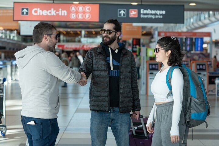 Friendly welcome handshake at Ezeiza Airport between driver and arriving passengers