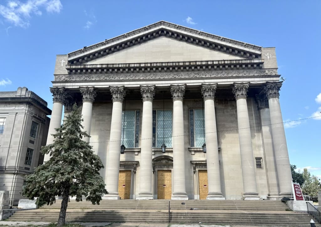 Neoclassical stone facade with white Corinthian columns and triangular pediment in St. Louis Central West End