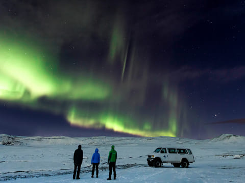 small group of people enjoying the northern lights tour in Iceland