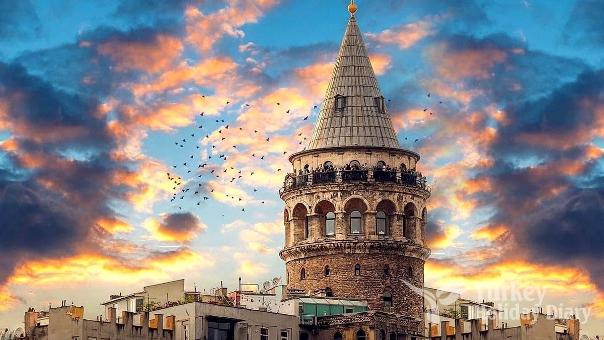 Galata Tower glowing at sunset — a postcard-perfect view of Istanbul under dramatic skies.