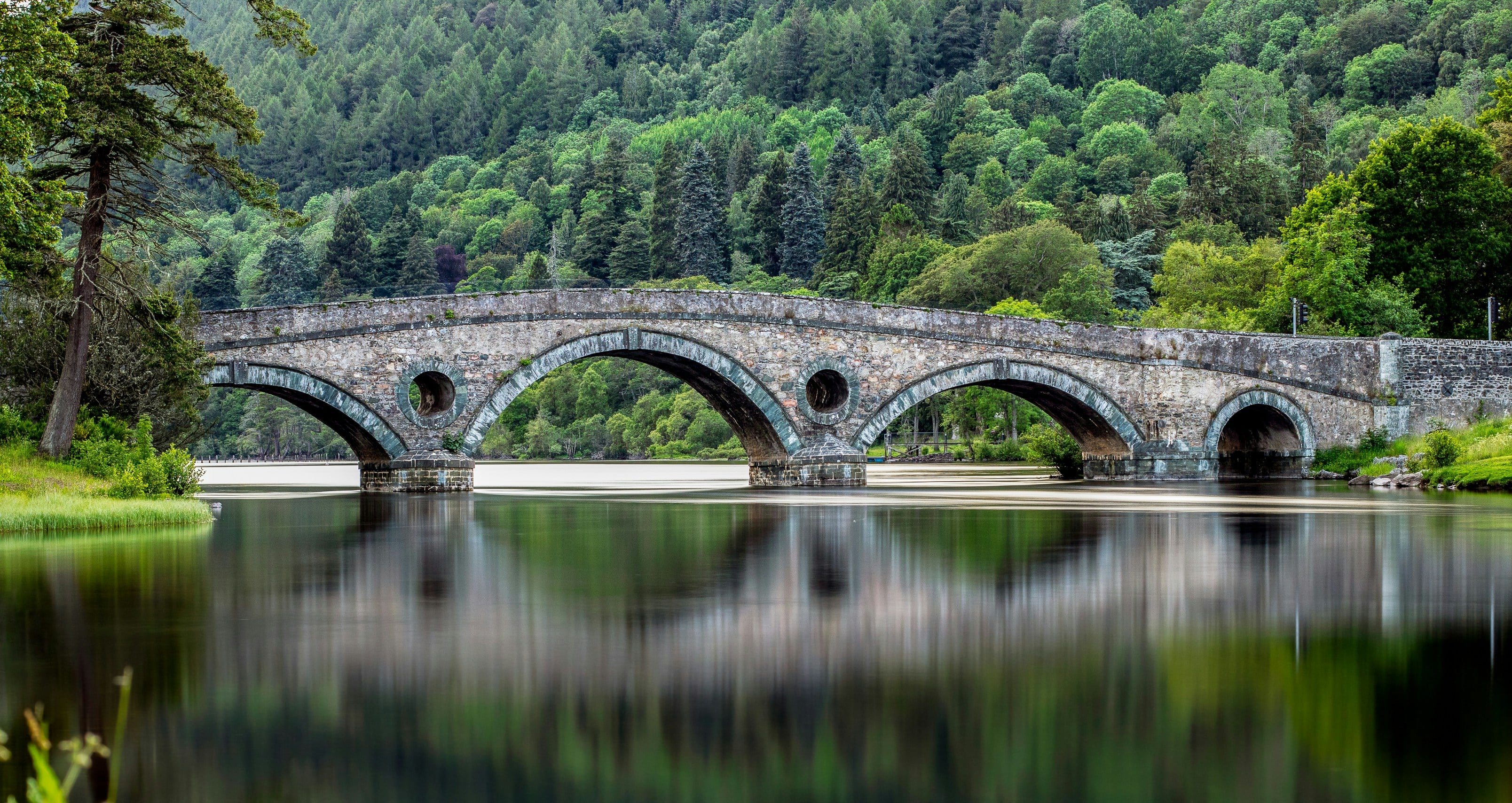 Bridge over still loch
