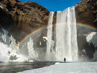 A rainbow formed at the basin of Skogarfoss