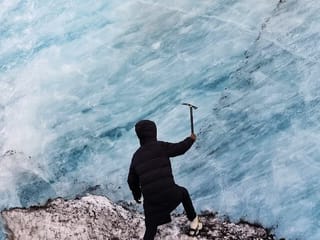 In front of wall of blue ice.