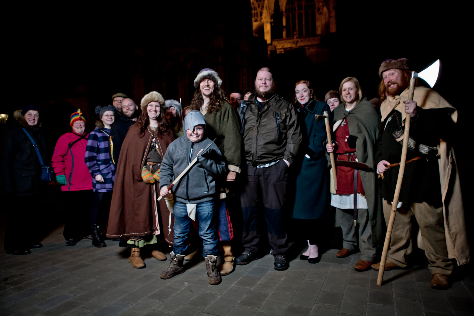A viking man with a large group of tourists at York Minster.