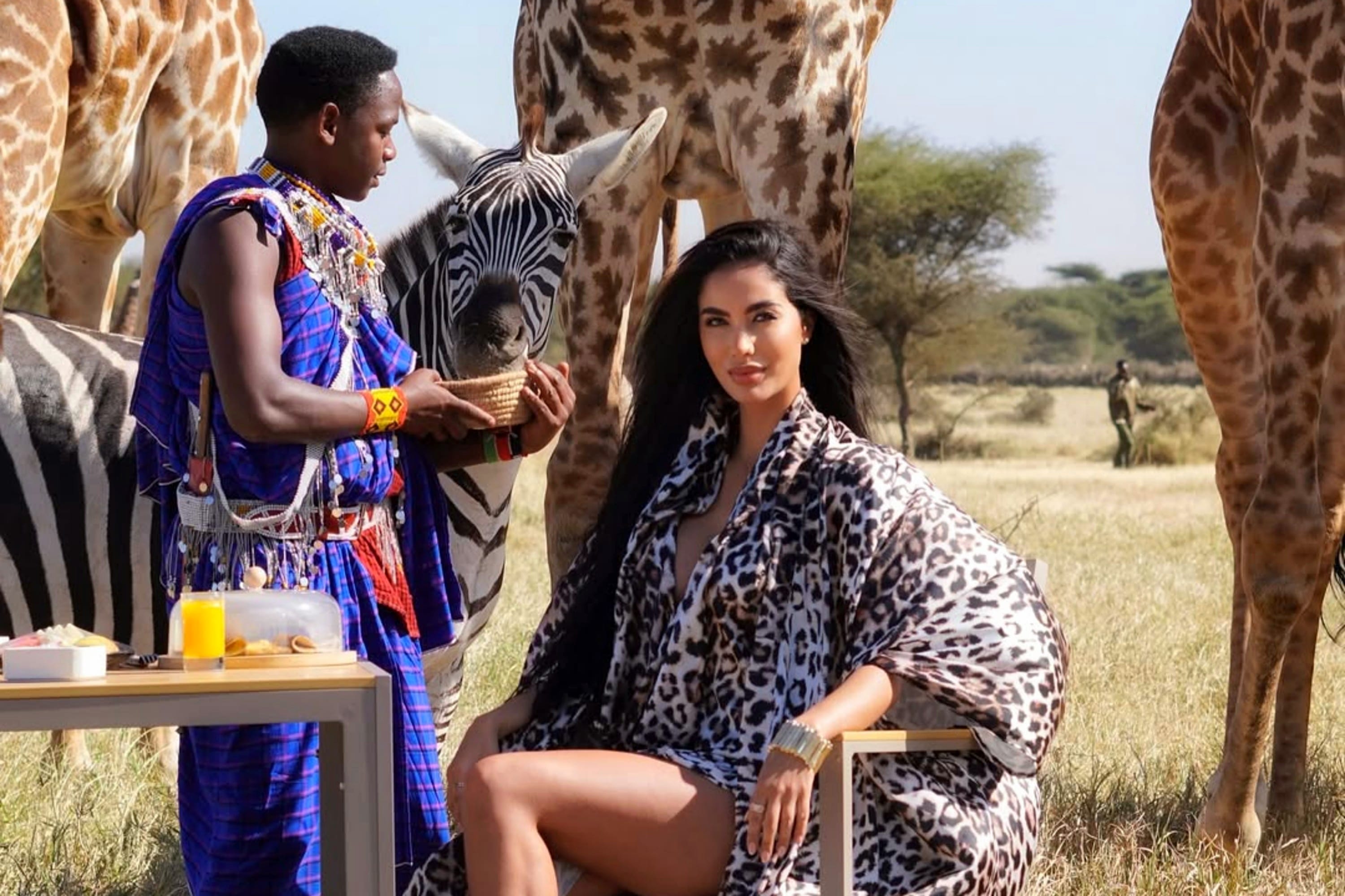 ​A luxury traveler in a private sanctuary featuring Maasai heritage and close wildlife interaction.