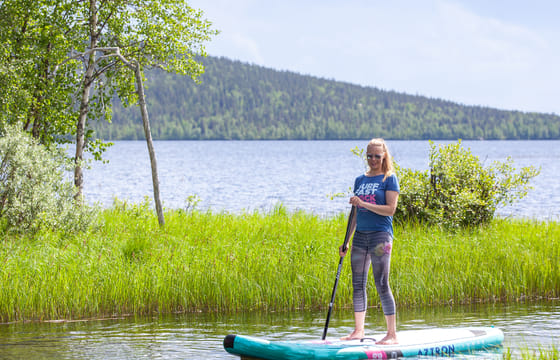 Arctic summer SUP boarding on a lake and river