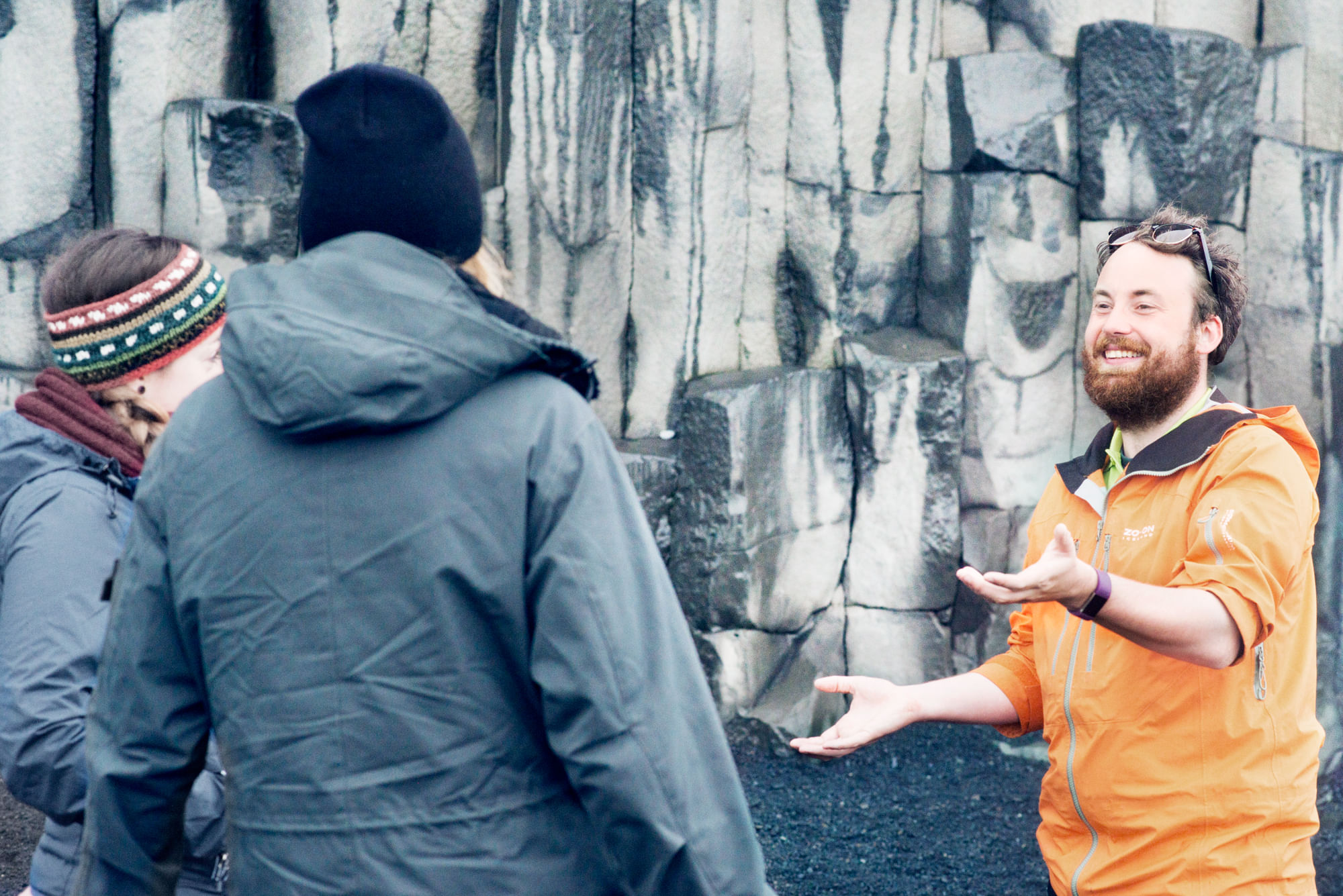 Guide explaining the basalt formation at Reynisfjara beach