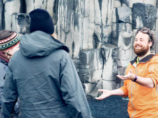 Guide explaining the basalt formation at Reynisfjara beach
