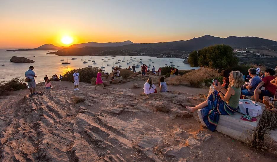Visitors exploring the ancient Poseidon Temple on a half-day trip from Athens.