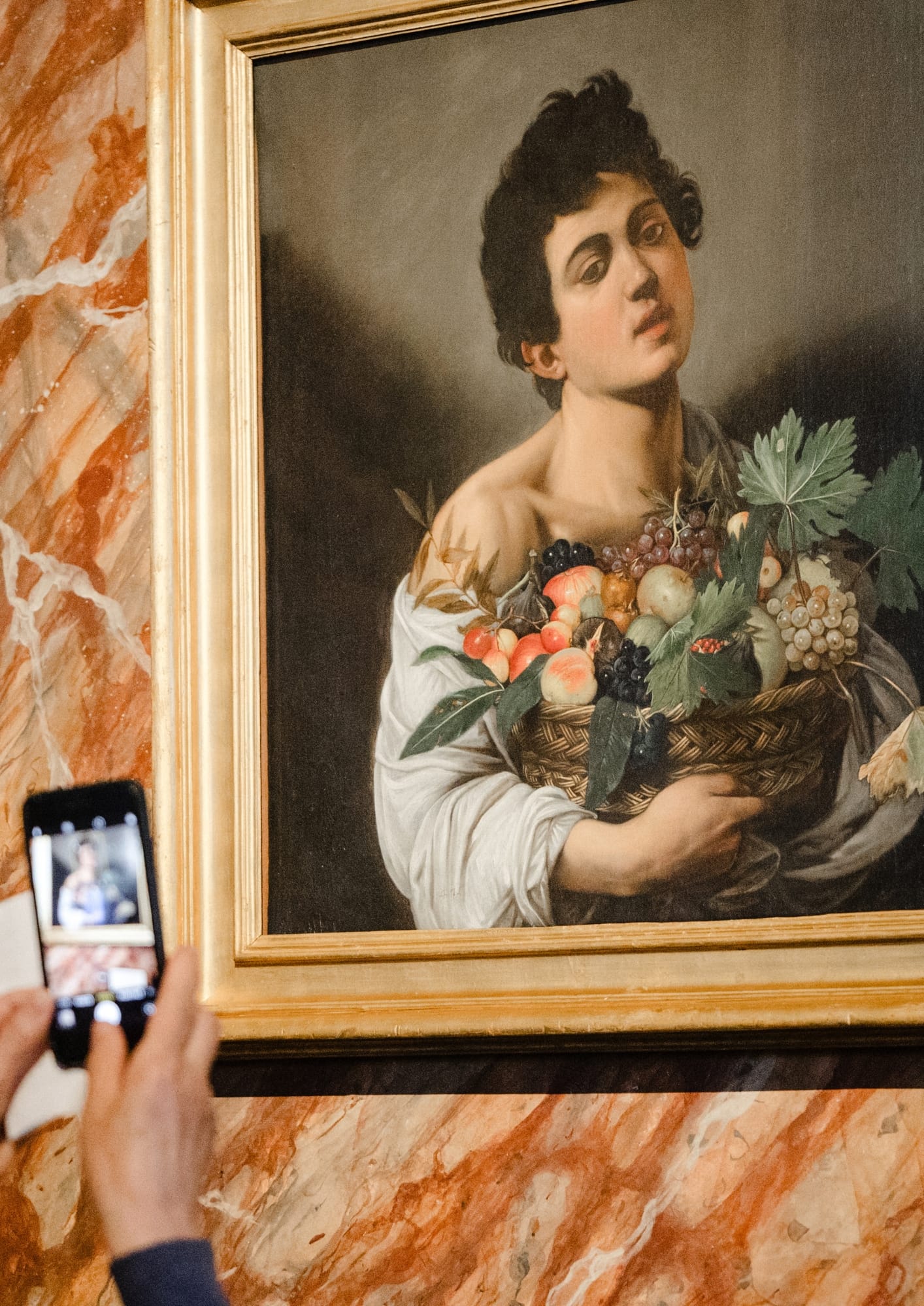 Step close to Caravaggio’s young boy, his basket overflowing with ripe fruit — a simple scene made intensely real by light and shadow.