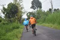Downhill cycling through local farmers plantation