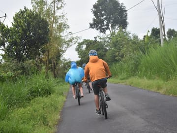 Downhill cycling through local farmers plantation