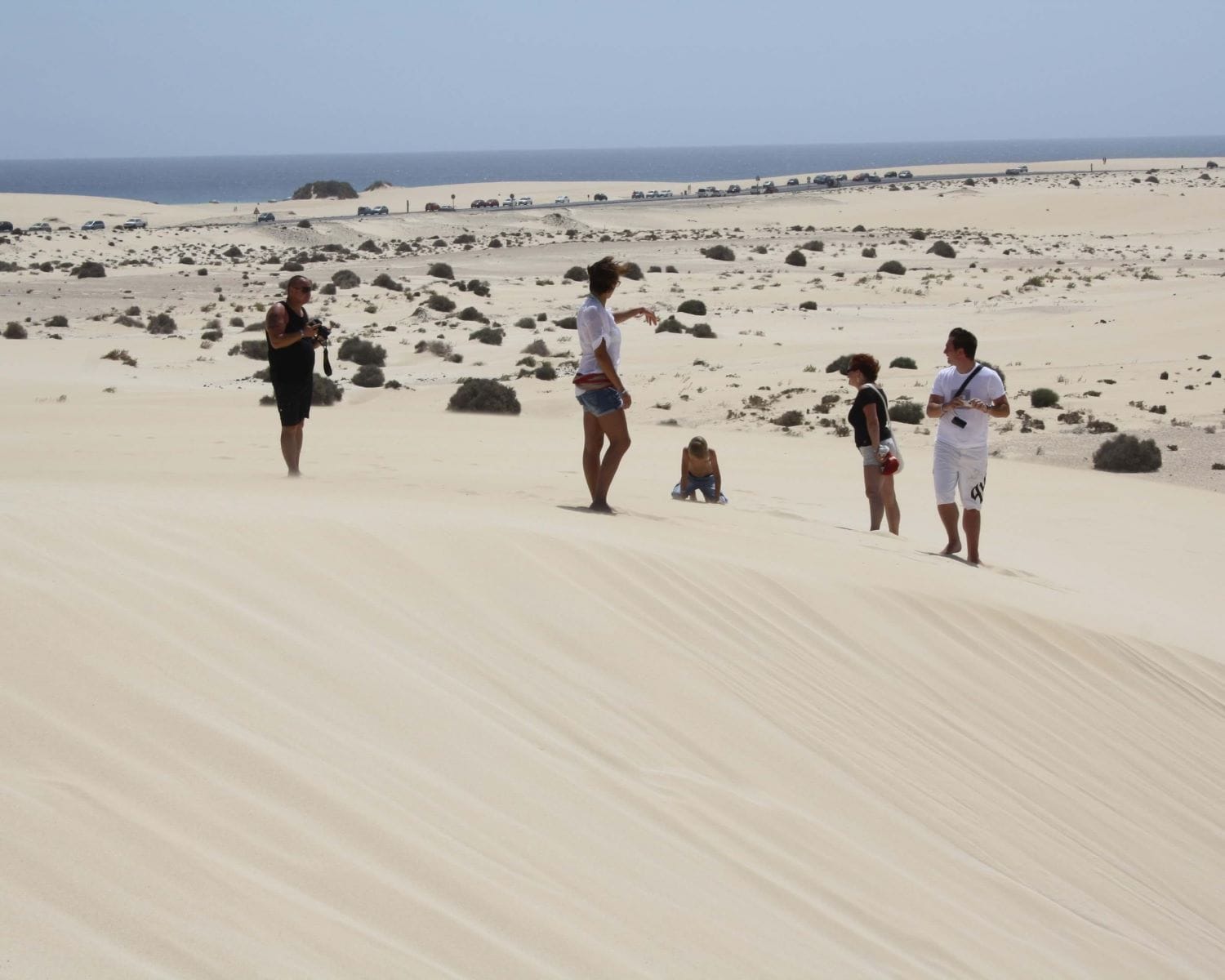 People walking on sand dunes in Fuerteventura