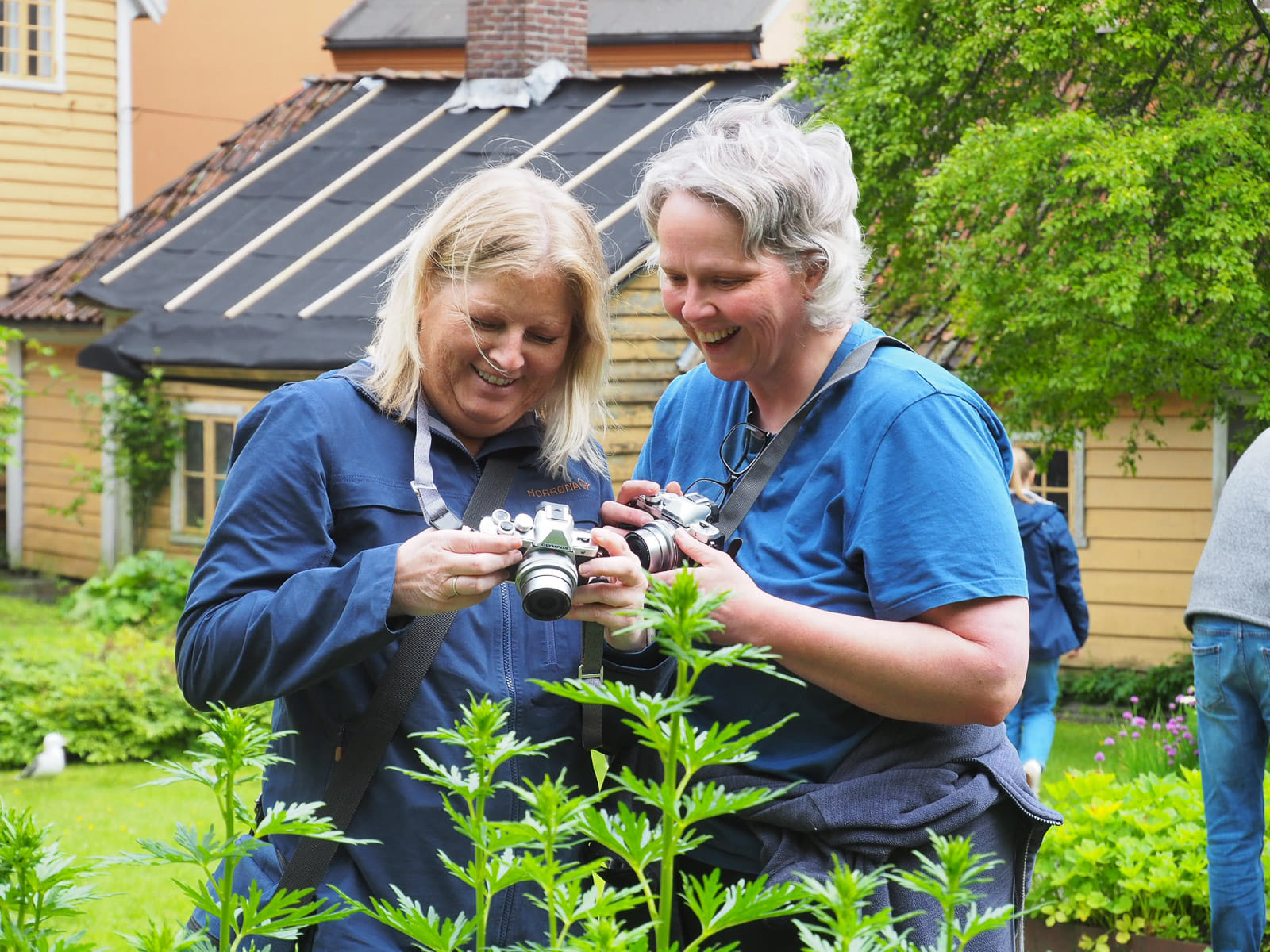 Two participants review photos together outdoors, capturing the social and hands-on learning experience of the photowalk.