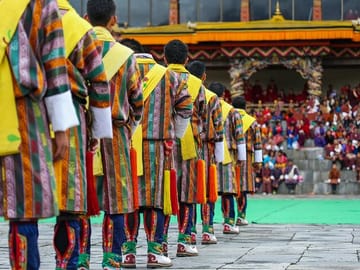 Folk dancers in traditional dress entertaining spectators at one of the annual festivals