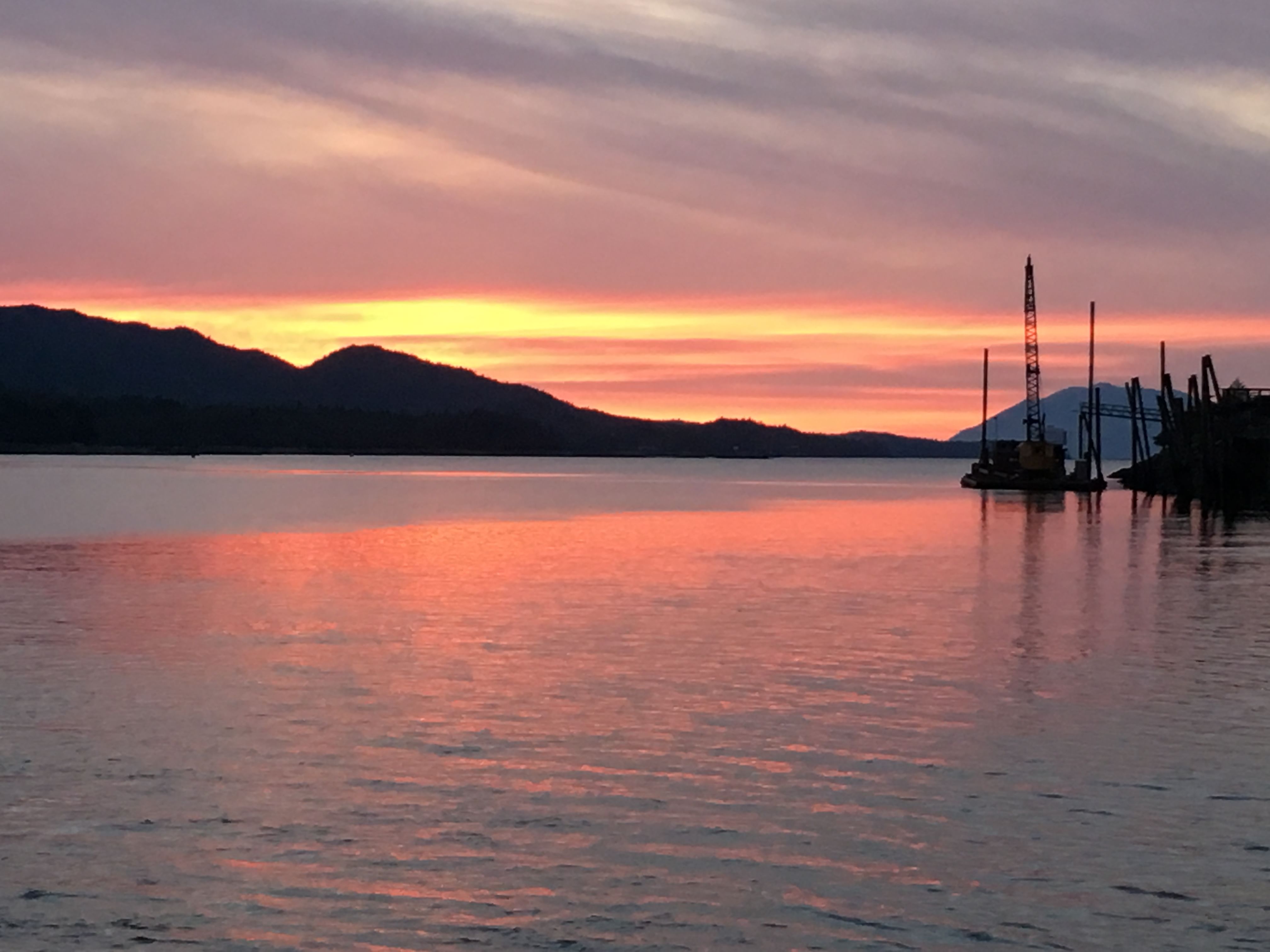 Orange and pink sunset over calm water