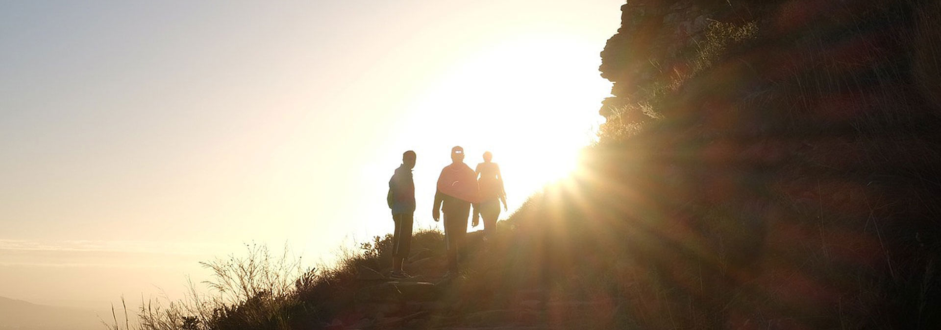 Stunning sunrise silhouettes atop Table Mountain during a guided hiking adventure.