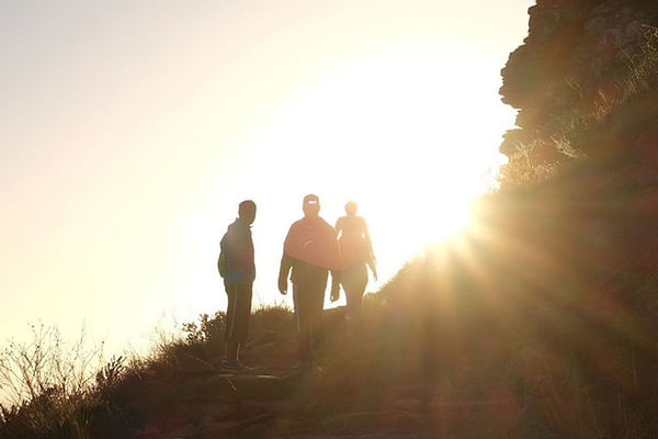 Stunning sunrise silhouettes atop Table Mountain during a guided hiking adventure.