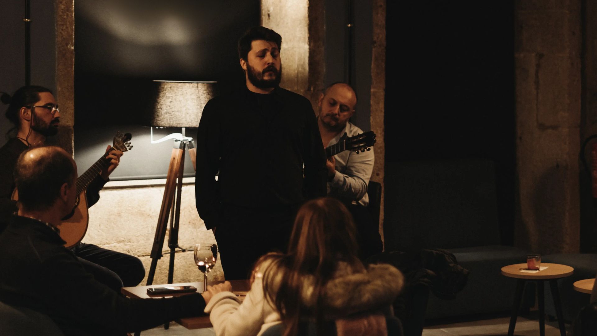 Traditional Fado concert in Porto with seated audience and candle-lit atmosphere