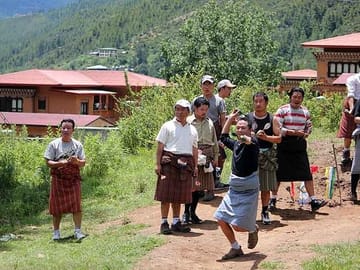 Playing traditional game of dart local known as Khuru