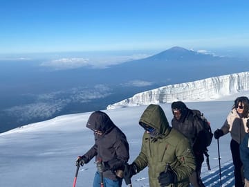 Witness the breathtaking beauty of the African continent from above the clouds as you traverse Kilimanjaro’s ancient glaciers.