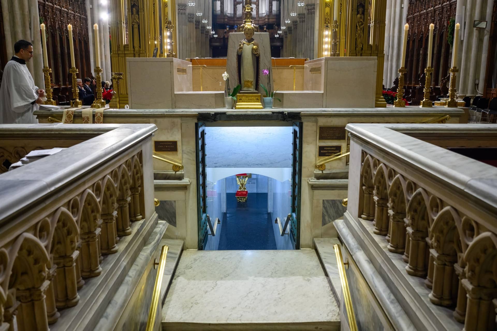 St Patrick's Cathedral crypt viewed from marble staircase with ornate railings and altar visible above