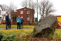 Guests receiving an explanation about elf stones in Iceland