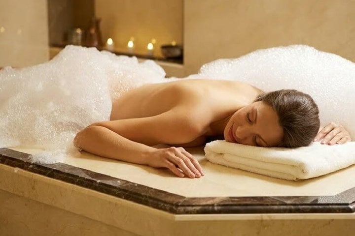 A woman relaxing during a traditional Moroccan hammam foam treatment.