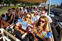 "A group of tourists takes in the sights of Dubai from the Big Bus, making their visit a memorable and enjoyable experience."