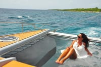 Relax and soak up the sun on the yacht's bow net with endless ocean views.