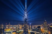 Nighttime view of Dubai's illuminated landmarks.