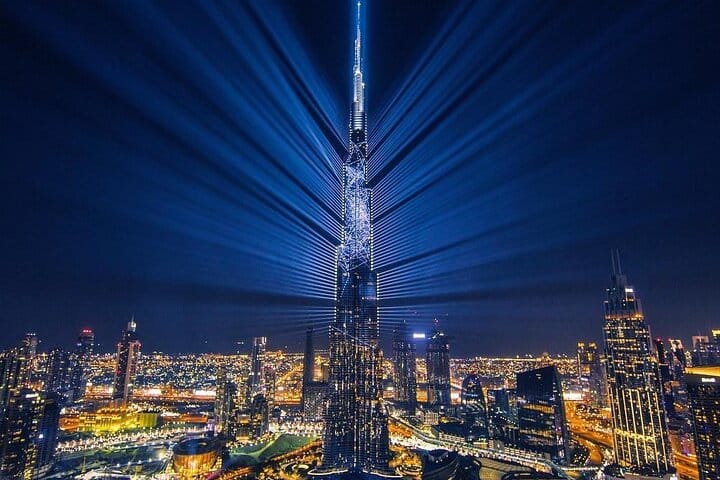 Nighttime view of Dubai's illuminated landmarks.