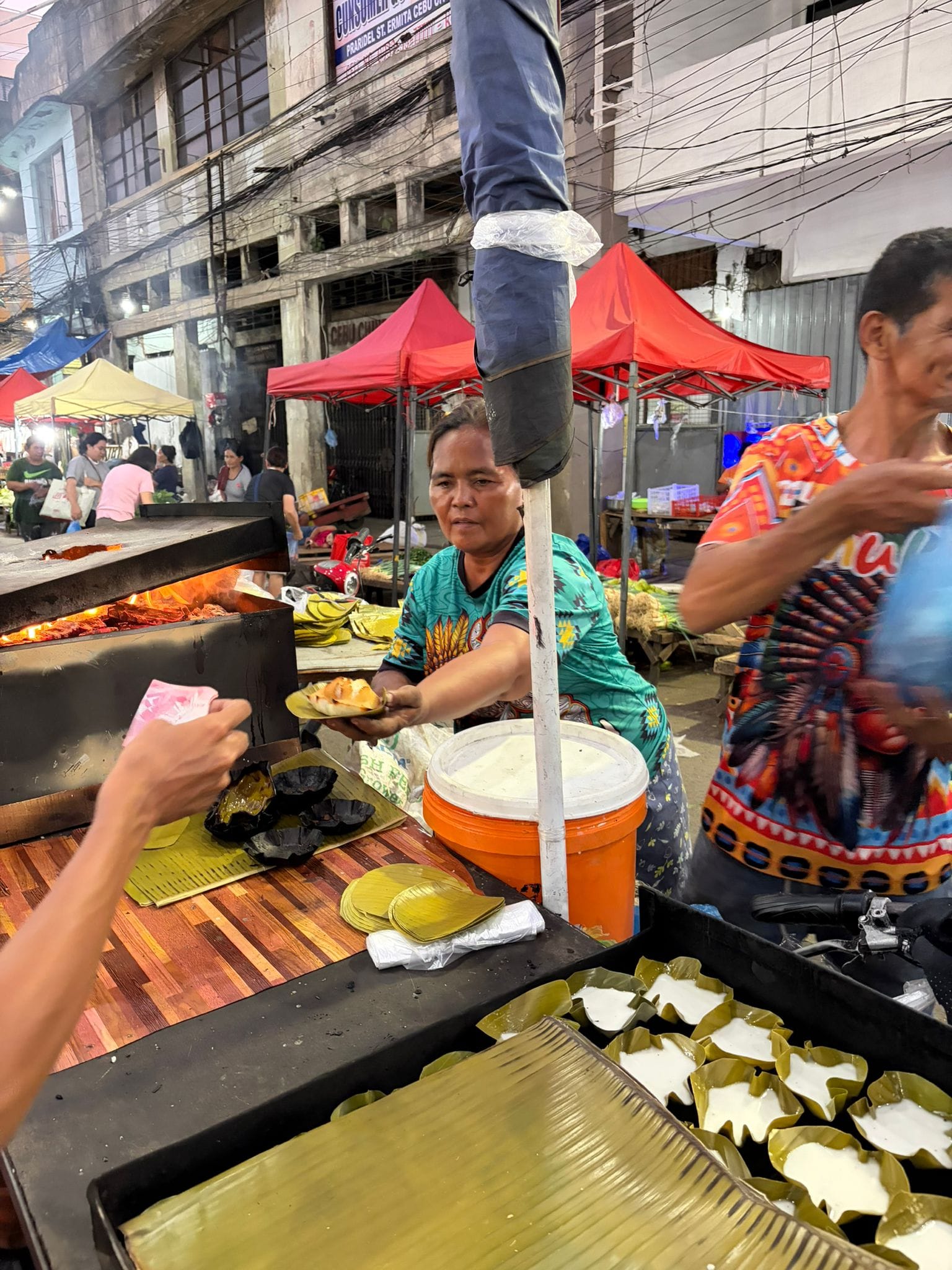 A local vendor serves freshly cooked Filipino bibingka at Carbon Market in Cebu. Food selections depend on availability and freshness.